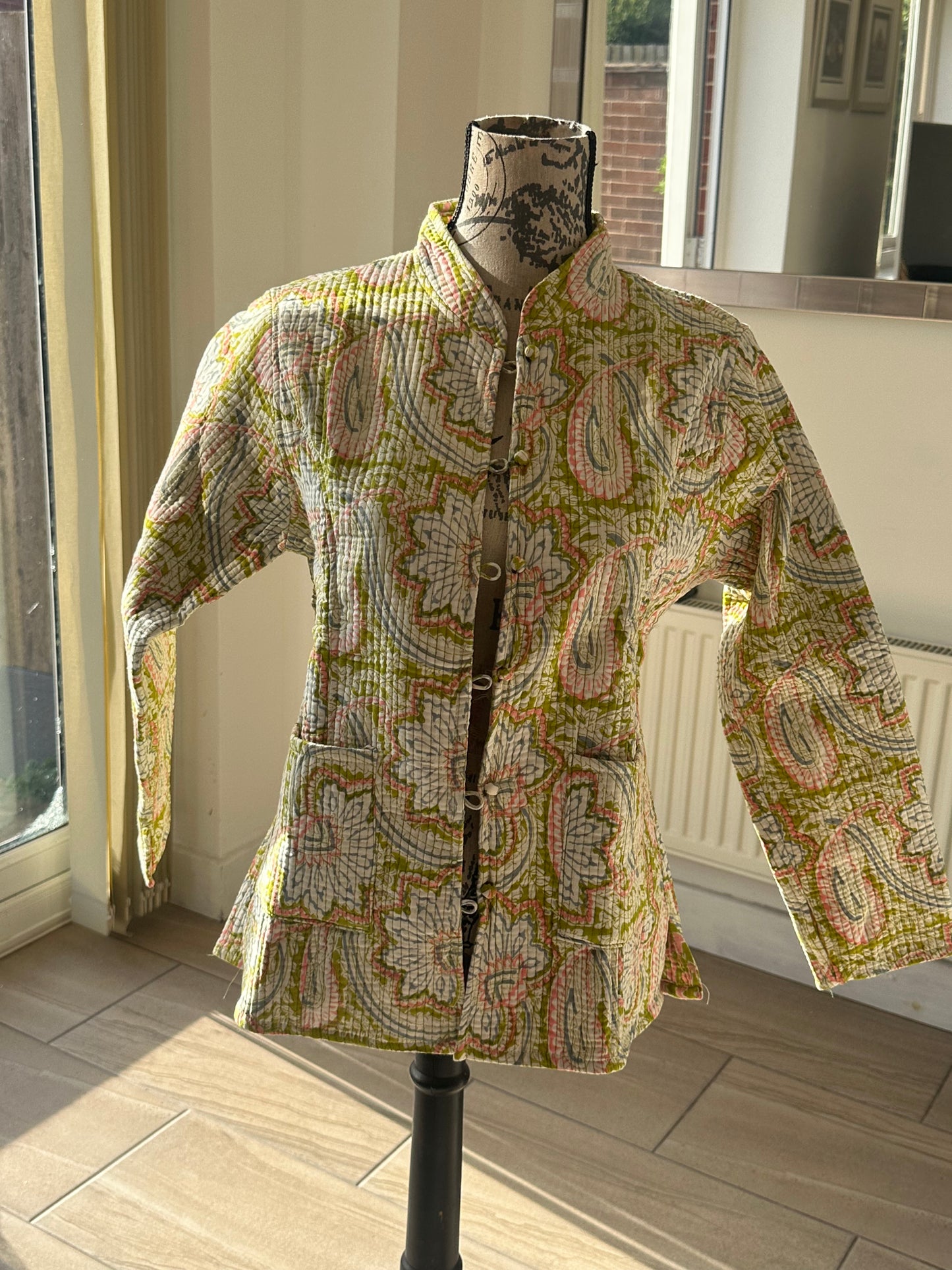 Reversible cotton coat showing handmade quilting detail