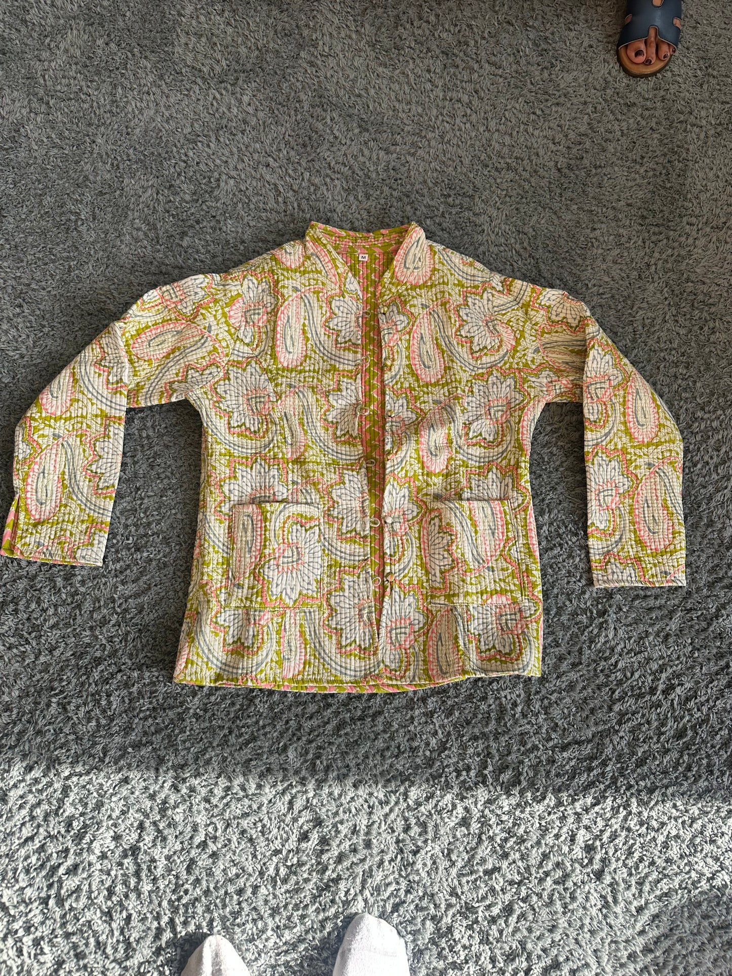 Close-up of traditional block print pattern on quilted jacket